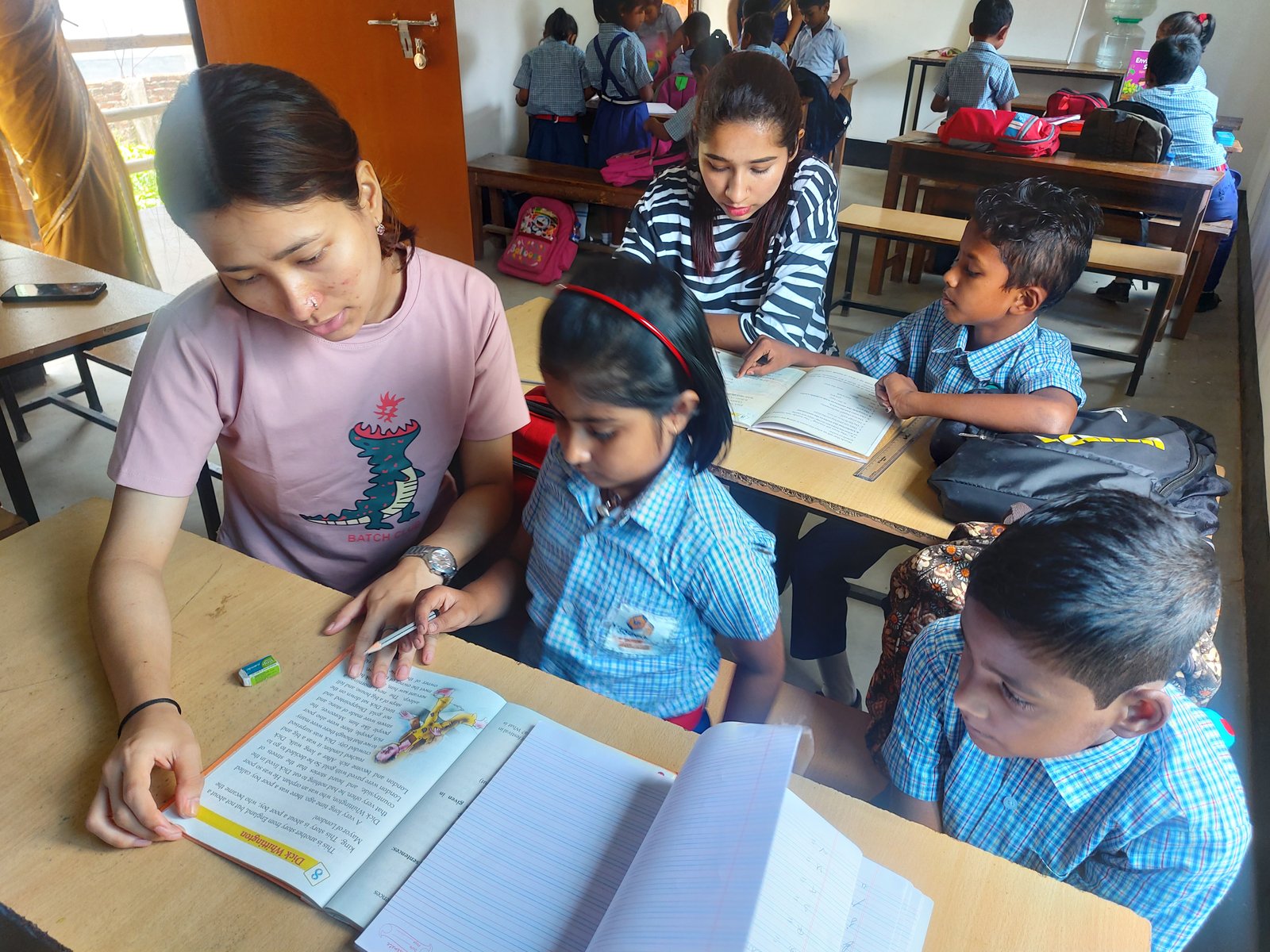Intern teaching children in a classroom
